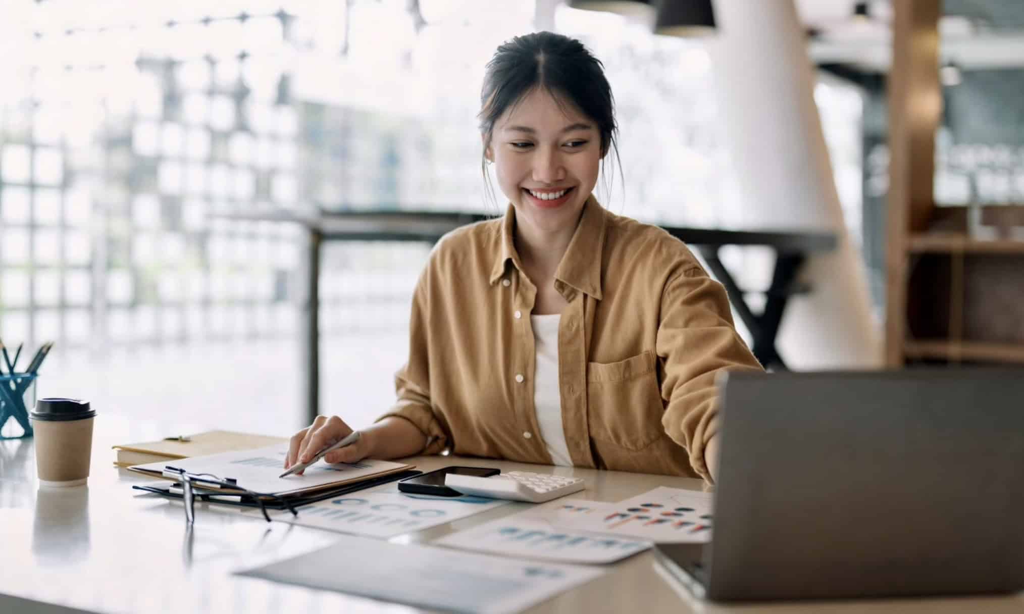 Small-business owner reviewing clean, tax-ready financials after catch-up bookkeeping